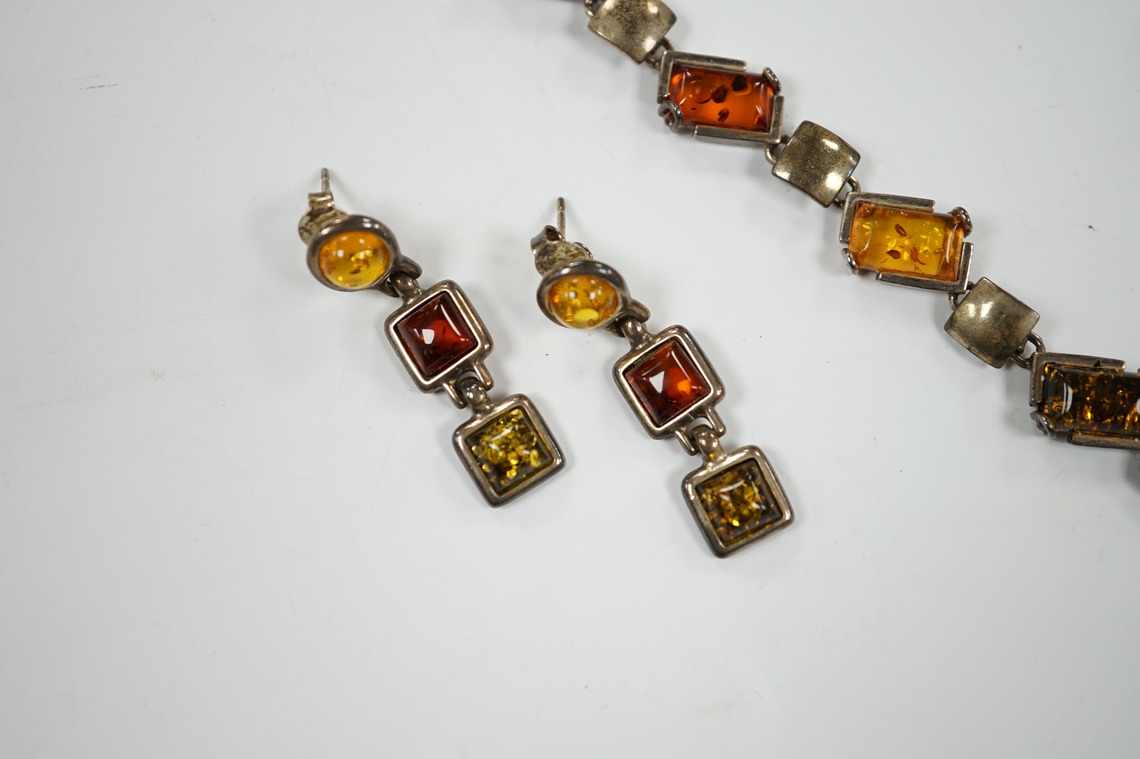 A modern 925 and three stone amber set pendant necklace, 42cm, together with a similar bracelet and pair of drop earrings.